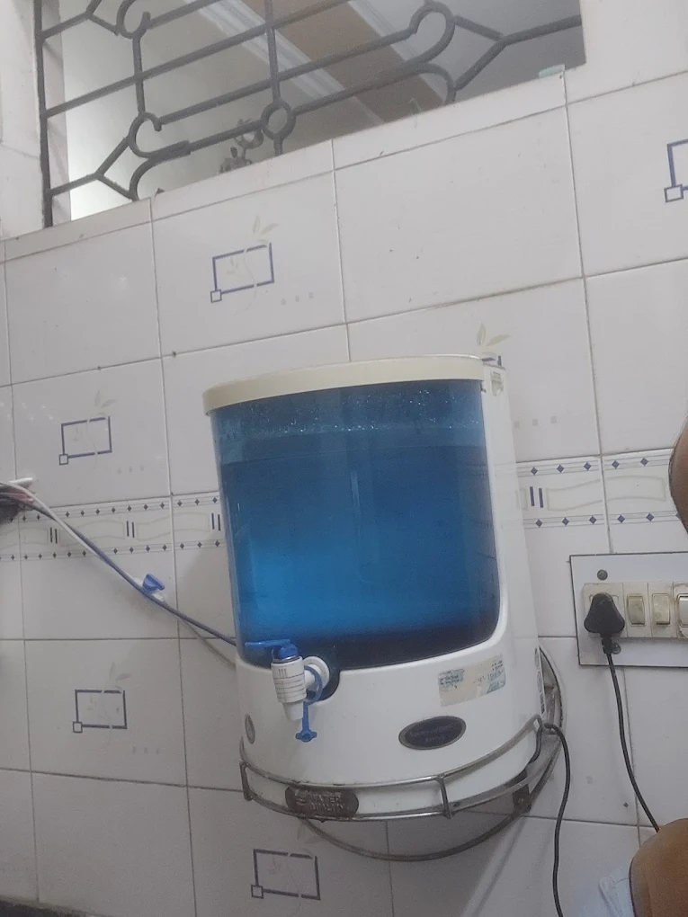 Blue and white water purifier installed in a home